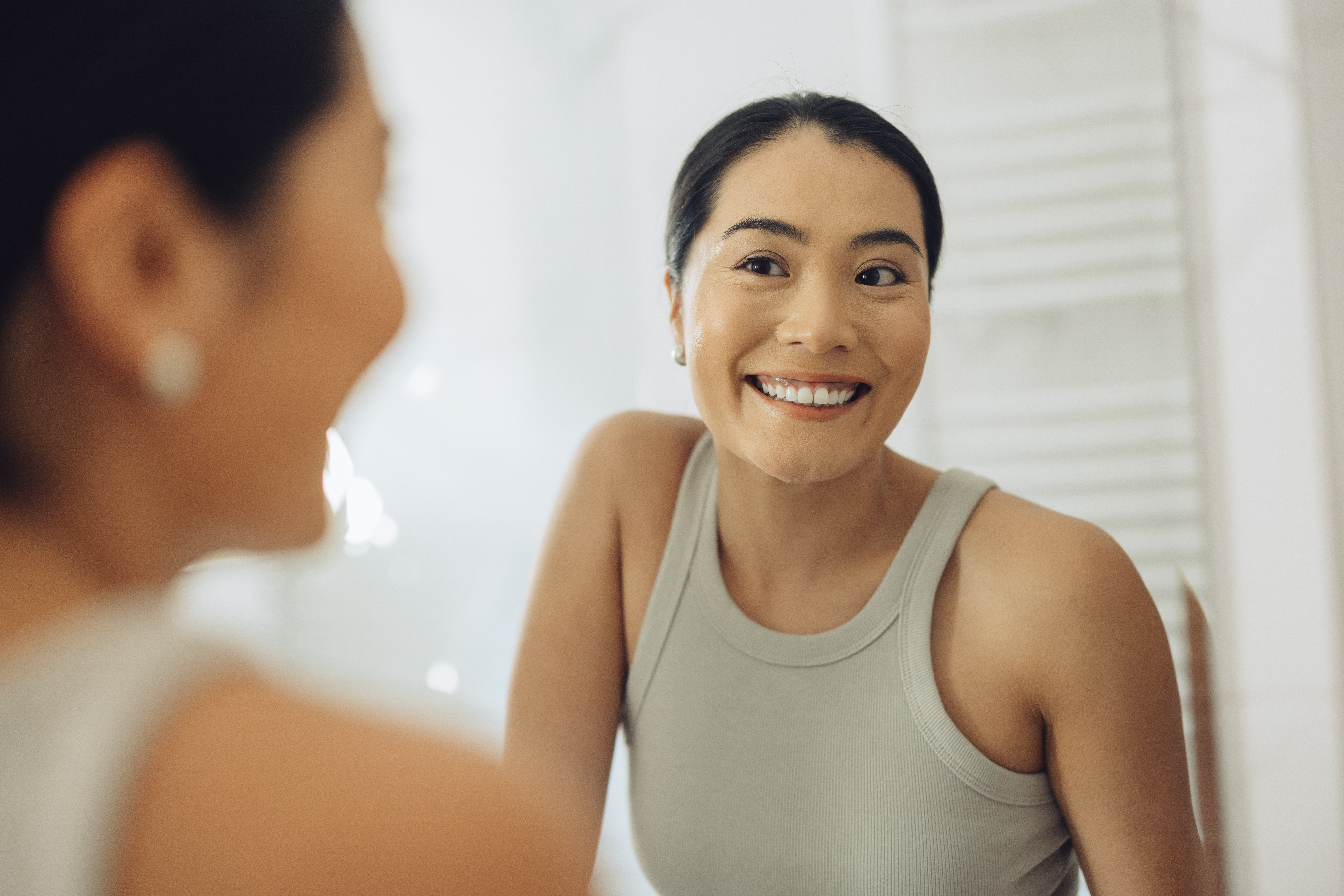 A girl smiling, showcasing whiten teeth at home